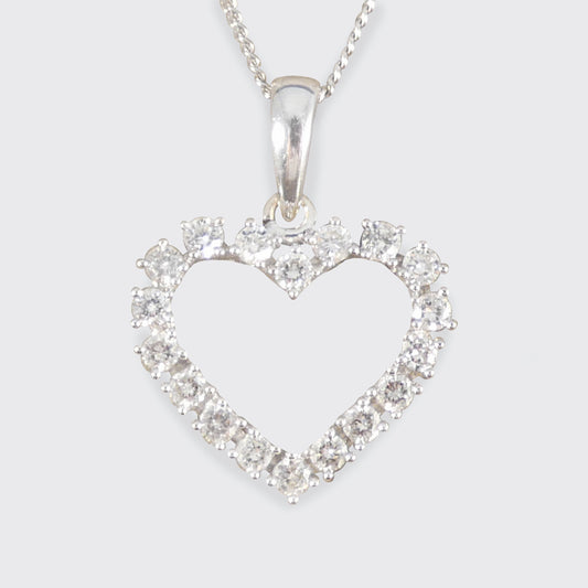 Heart-shaped 18ct white gold pendant with diamonds on a white background