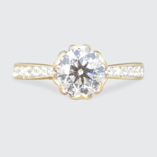 Gold ring with a large diamond on a light gray background