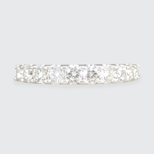Diamond eternity ring on a light gray background