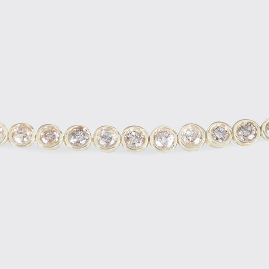 A champagne diamond tennis bracelet in 9ct yellow gold.