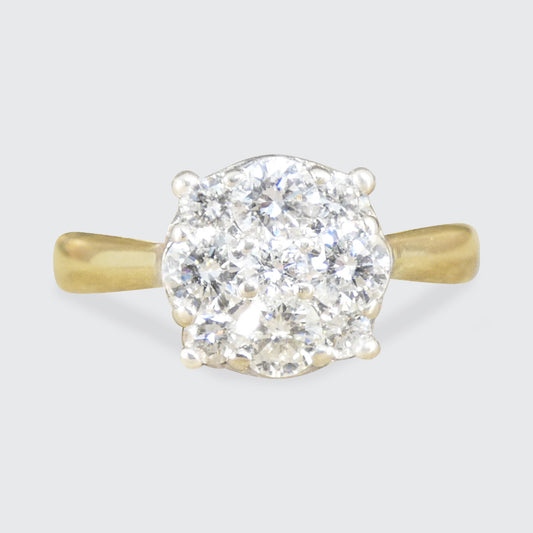 Gold ring with a large diamond cluster on a light gray background