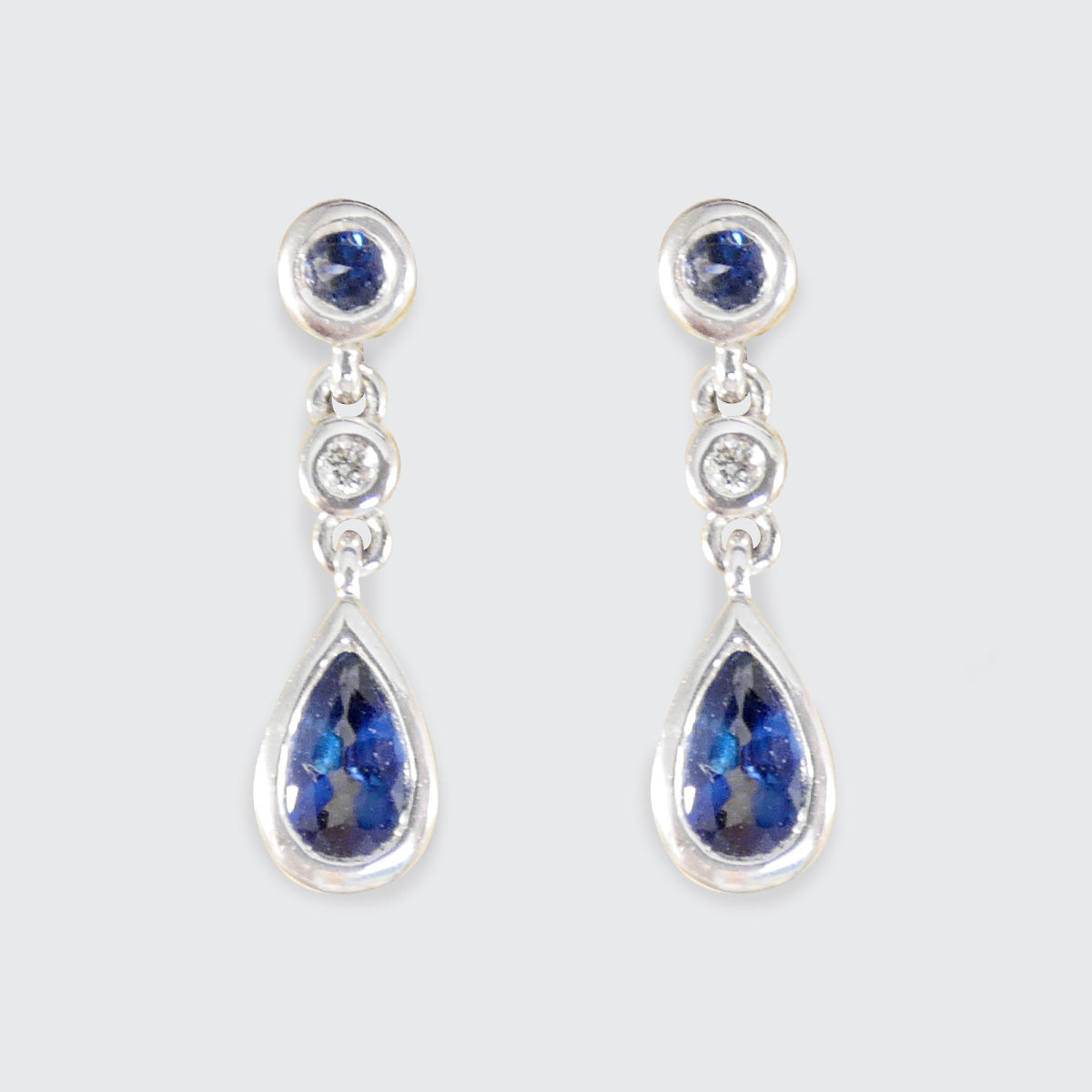 A pair of White Gold earrings are Ceylon Sapphire gemstones and diamonds.