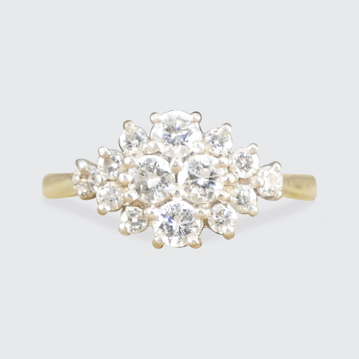 Diamond ring with gold band on a light gray background