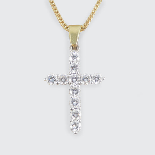 Diamond cross pendant necklace featuring brilliant-cut diamonds set in 18ct white gold with a yellow gold bail, suspended from a yellow gold chain.