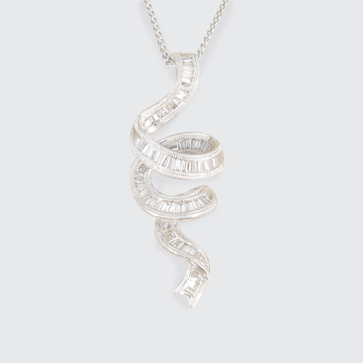 Diamond Set Ribbon shaped pendant necklace on a light gray background