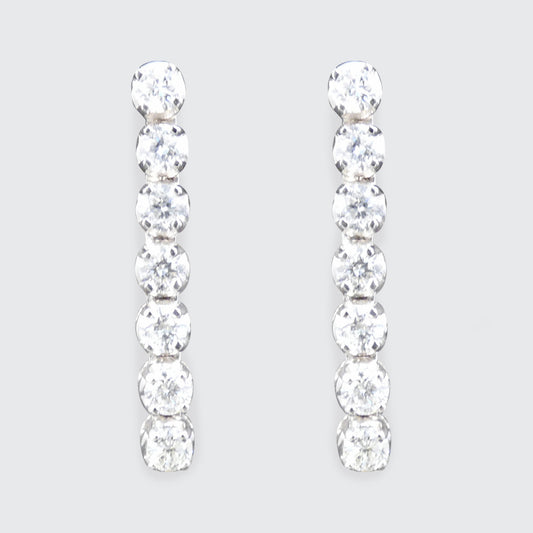 Pair of diamond earrings on a light gray background
