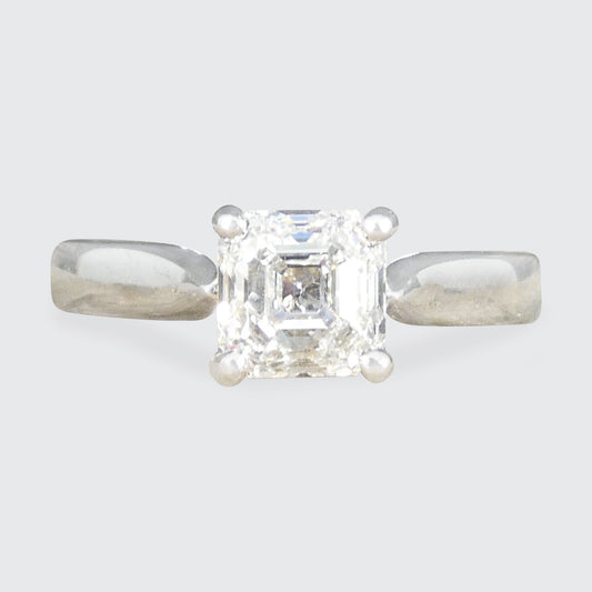 A Squared Emerald Cut Diamond Solitaire Engagement Ring in a four claw setting with a chunky Platinum band and modern feel.
