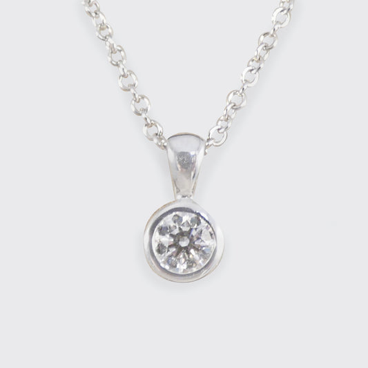 White gold necklace with a round diamond pendant on a white background