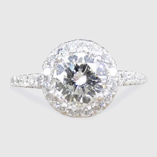 Diamond cluster ring with a diamond shoulders on a light gray background