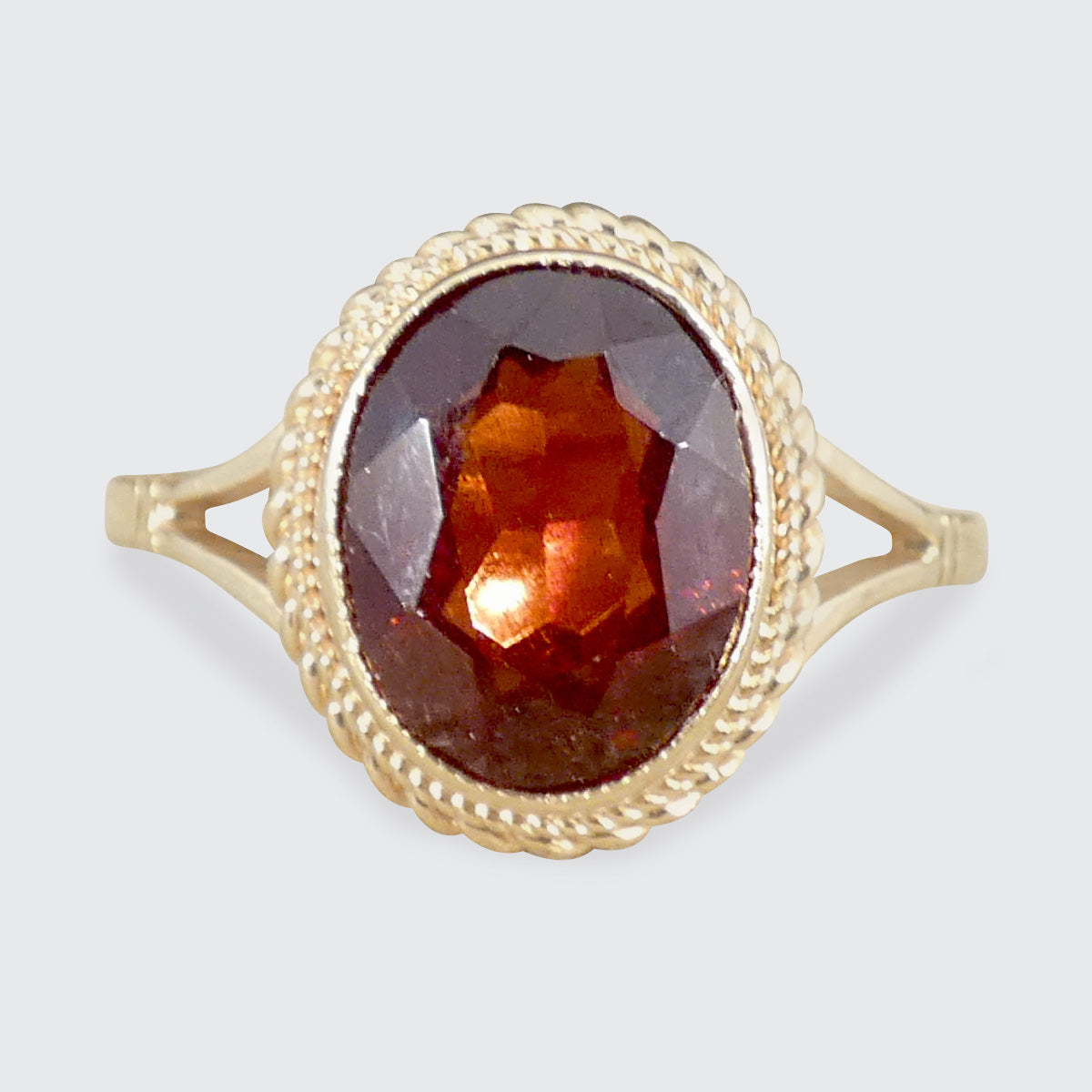 A Garnet and Gold surround ring.