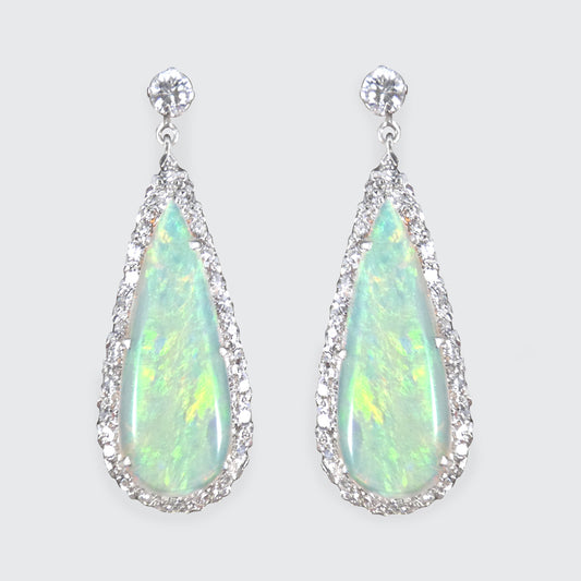 Vintage opal and diamond cluster drop earrings set in platinum, featuring luminous opal centres surrounded by sparkling diamond halos and elegant drop settings.