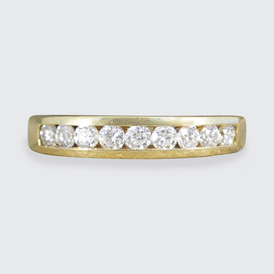 Gold ring with diamonds on a light gray background