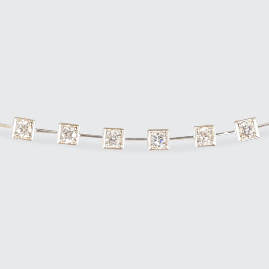 Elegant tennis bracelet crafted in 18-carat white gold, featuring a unique design with square bezel-set diamonds totaling 1.50 carats. The modern aesthetic and timeless sparkle make this bracelet a sophisticated choice for any occasion.