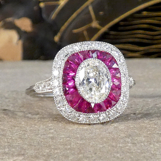 showing a bright and beautiful red pink hue with this Art Deco Style Ruby and Oval Cut Diamond Target Cluster Ring in Platinum