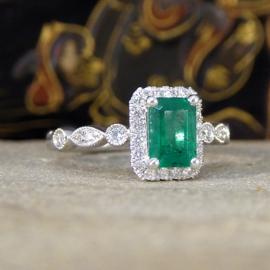 1.05ct Emerald and Diamond Cluster Ring with Diamond Adorned Shoulders in Platinum - Wharfedale Antiques