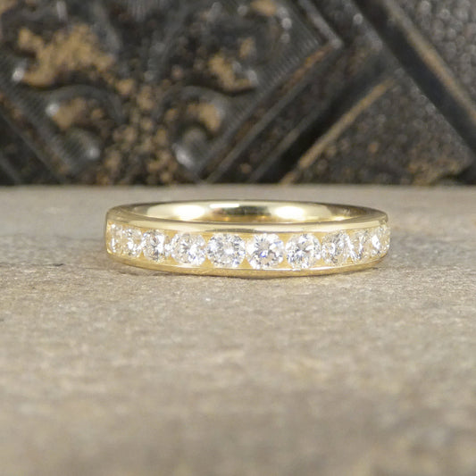Gold ring with diamonds on a textured surface