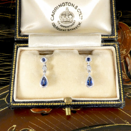 Teardrop-shaped sapphire and diamond earrings in a jewellery box.