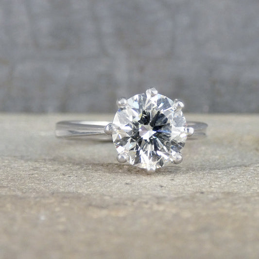 Diamond ring on a textured surface with a blurred background