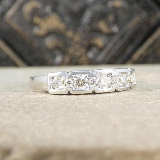 Silver ring with diamonds on a textured surface