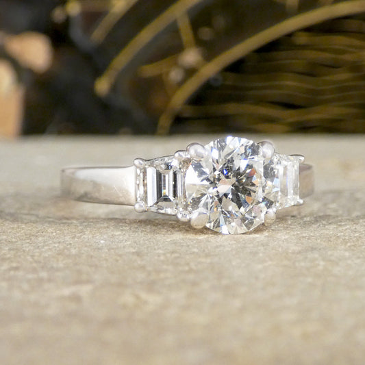 A brilliant cut and trapezoid cut Diamond three stone ring.