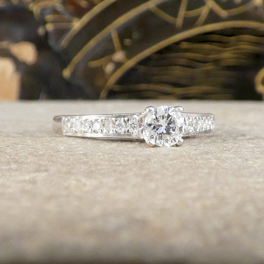 Diamond ring on a textured surface with blurred decorative background