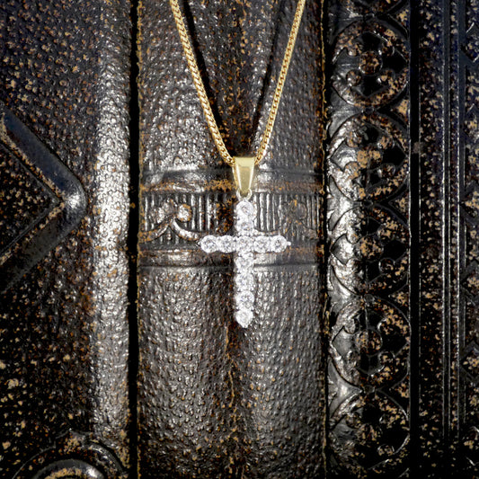 Diamond cross pendant necklace featuring brilliant-cut diamonds set in 18ct white gold with a yellow gold bail, suspended from a yellow gold chain.