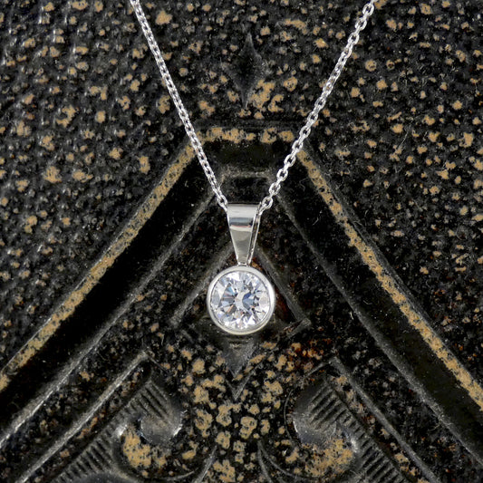 The perfect gift featuring a gorgeous and bright diamond in a bezel setting in platinum.
