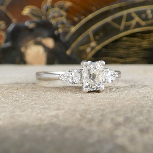Diamond ring on a textured surface with a blurred decorative background