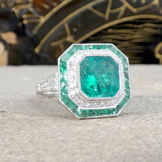 A gorgeous a striking Emerald and Diamond cluster ring.