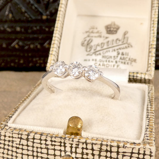 A diamond ring set with three equally sized brilliant cut diamonds in a two claw setting weighing just over half a carat.