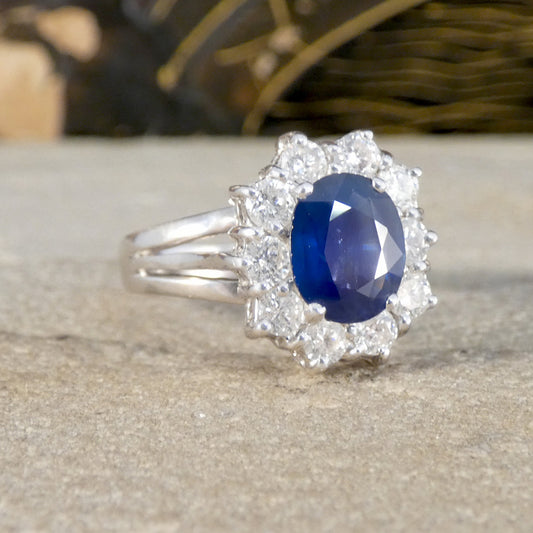 Silver ring with a blue gemstone on a wooden surface