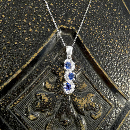 Ceylon Sapphire and Diamond Three Stone Lazy River Drop Pendant Necklace in Platinum - Wharfedale Antiques