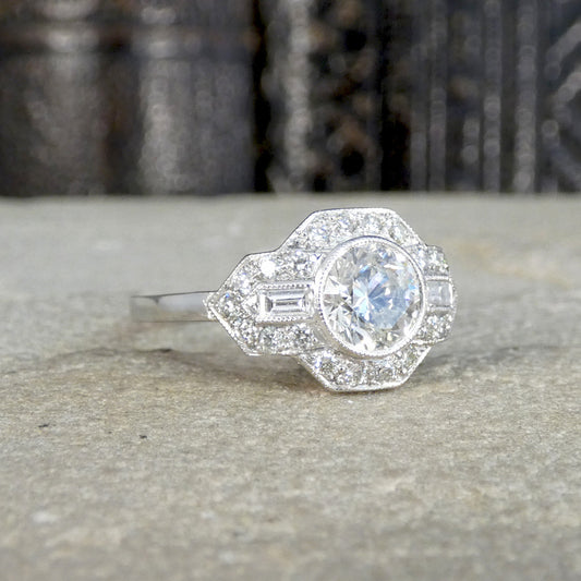 A gorgeous Art Deco inspired Diamond cluster ring in Platinum. Featuring a 1.01ct brilliant cut diamonds centre in a rub over bezel setting.