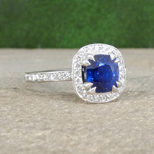 Sapphire and Diamond Halo Cluster Ring in Platinum with a wedfit design