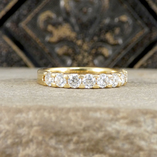 Gold ring with diamonds on a textured surface