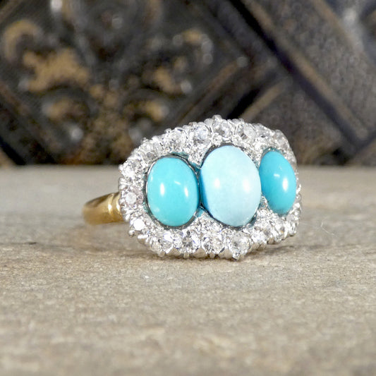 Ring with turquoise stones and diamond-like accents on a textured surface