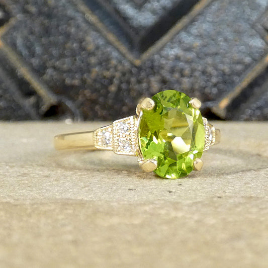 The oval cut Peridot is set in a four claw setting and showcased beautifully with staged Diamond set shoulders.