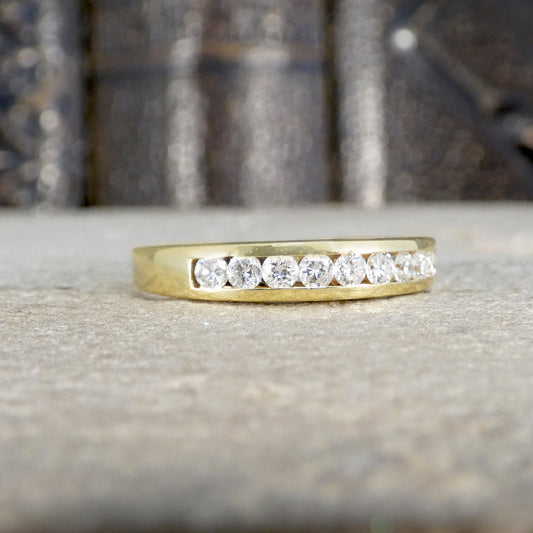 Gold ring with diamonds on a textured surface