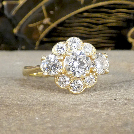 Gold ring with diamond cluster on a wooden surface