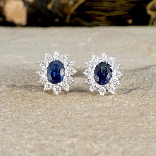 A pair of classic sapphire and diamond cluster earrings.