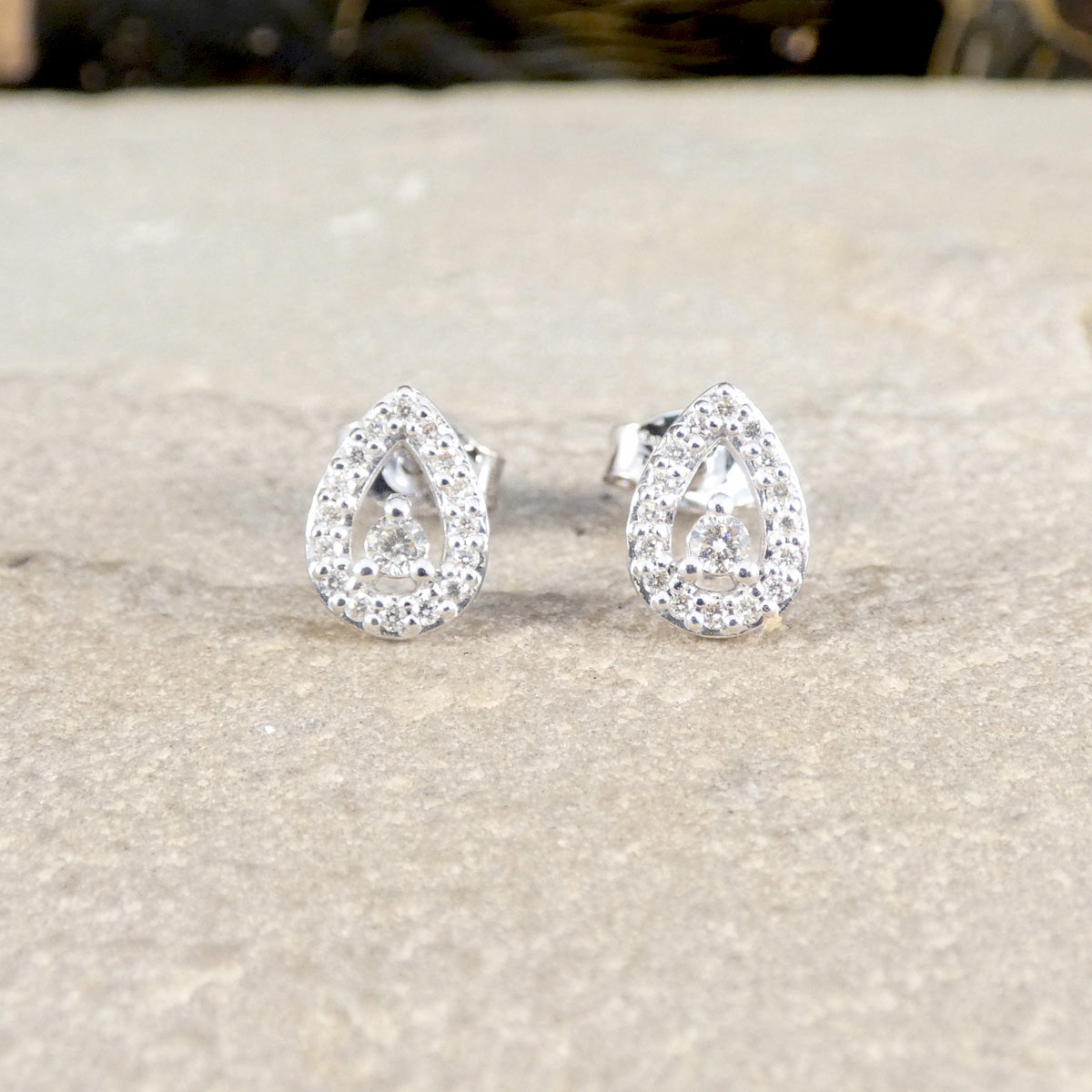Diamond cluster earrings in teardrop shape.