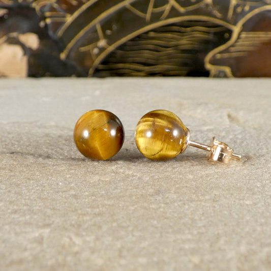 A pair of tigers eye stud earrings with 9ct yellow gold backs