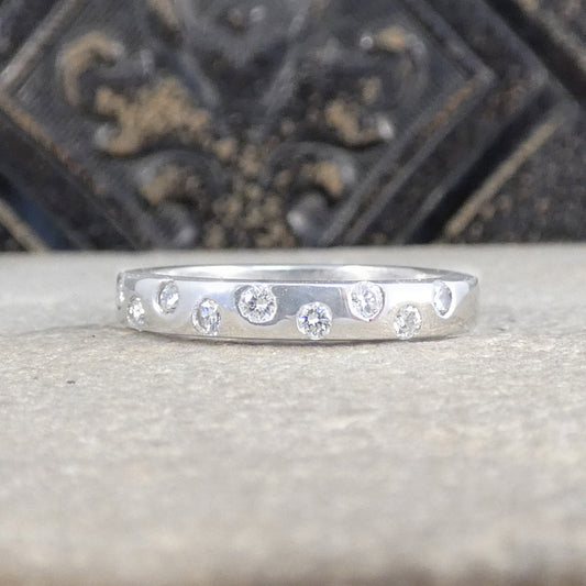 Chunky platinum band set with diamond spread half way around the band.