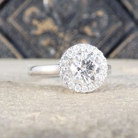 A diamond halo cluster ring with GIA certed centre stone with high colour and clarity in platinum.