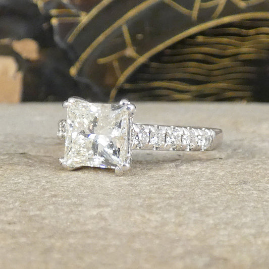 A gorgeous Princess cut Diamond Solitaire ring with diamond set shoulders in 18ct White Gold, the perfect engagement ring.