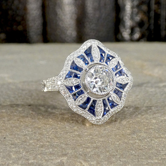 Gorgeous vintage ring featuring Diamonds and Sapphires in a floral sunburst design.