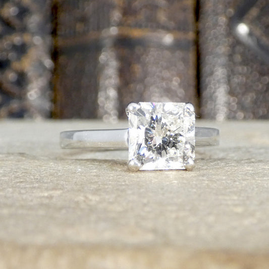 Diamond ring on a reflective surface with a blurred background