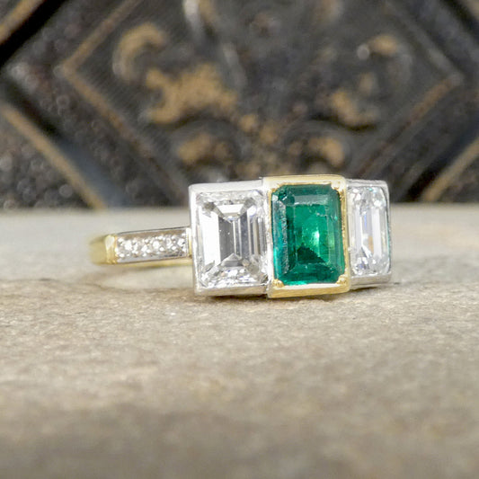 An Emerald and Diamond three stone ring in 18ct white and yellow gold.
