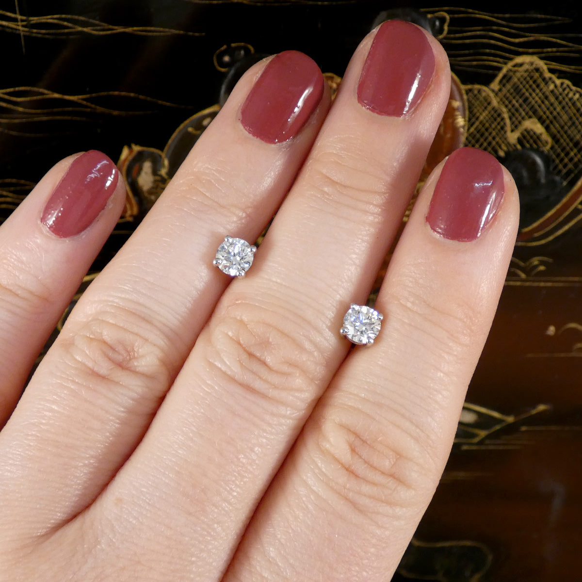1.00ct GIA E Colour Diamond Stud Earrings in 18ct White Gold. Gorgeous stud earrings displayed on the hnad for size and bright colour reference.