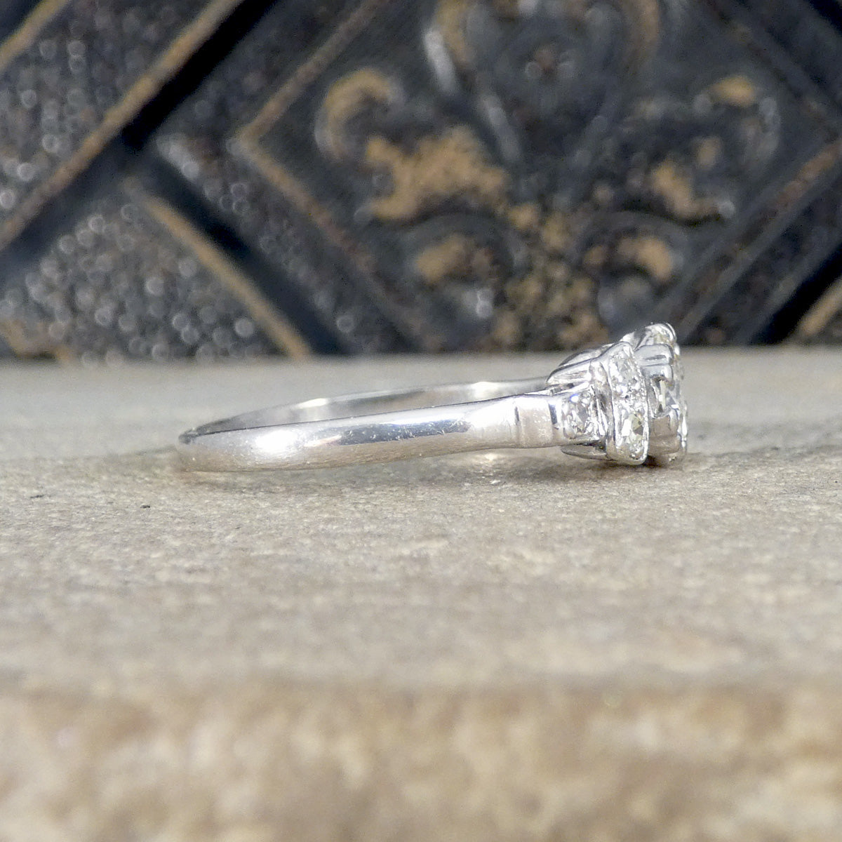 vintage ring with a diamond on a textured surface